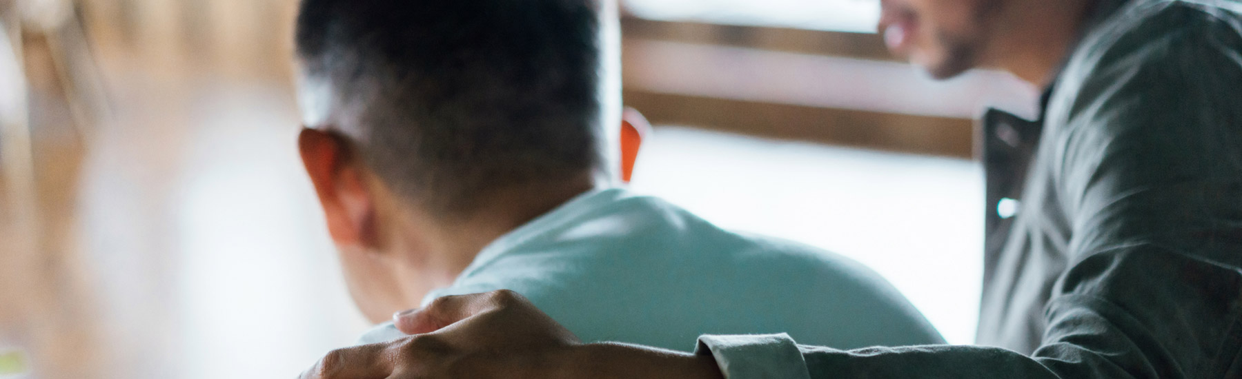 nchats-slider-option-01 A man with his arm around another man