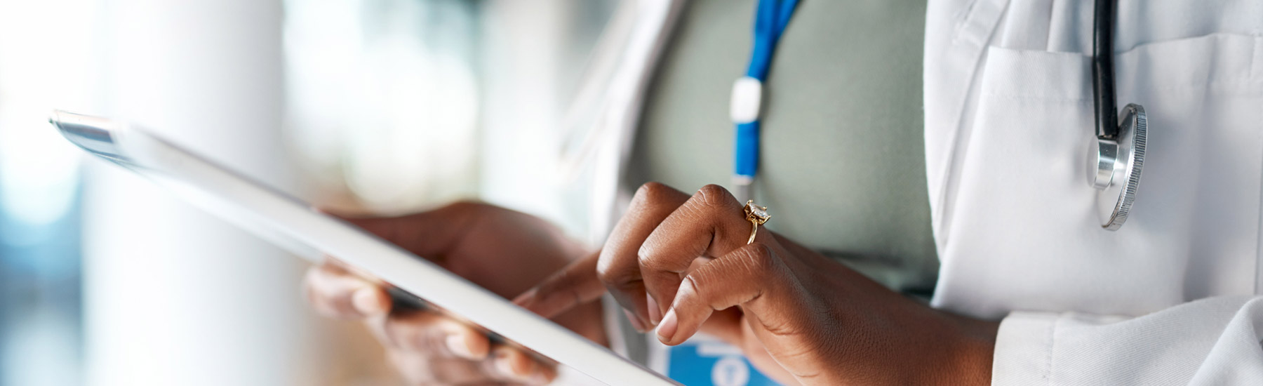 digital-health-data A medical professional's hand typing onto an iPad screen