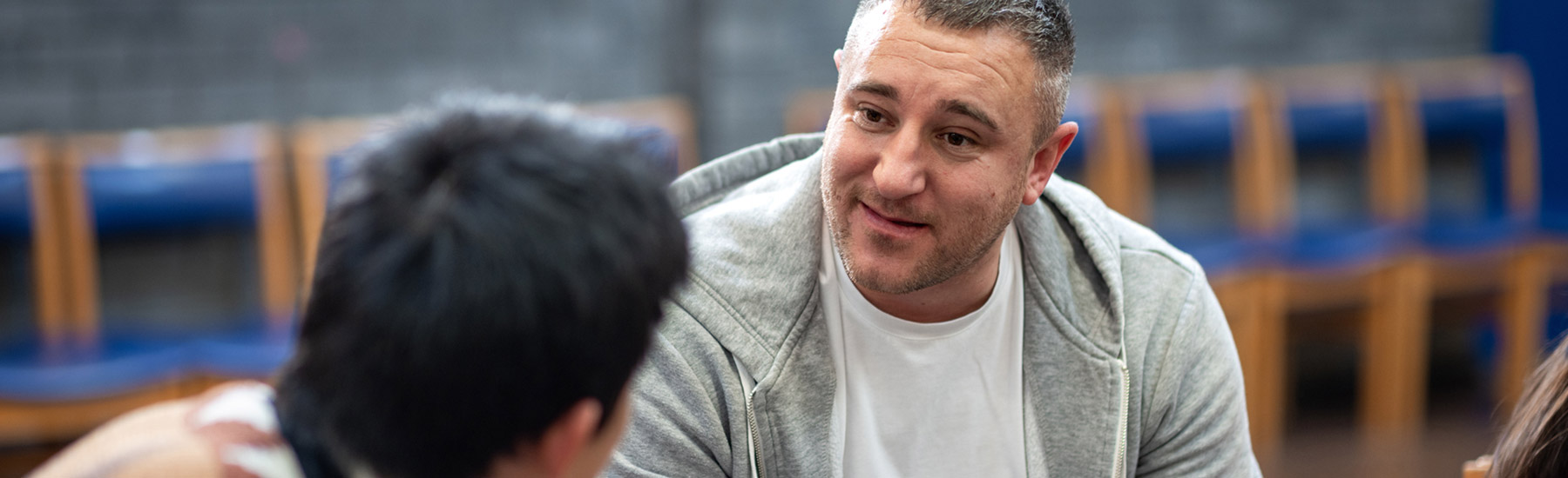 about-nchats A man in a gray jacket talking to a therapist