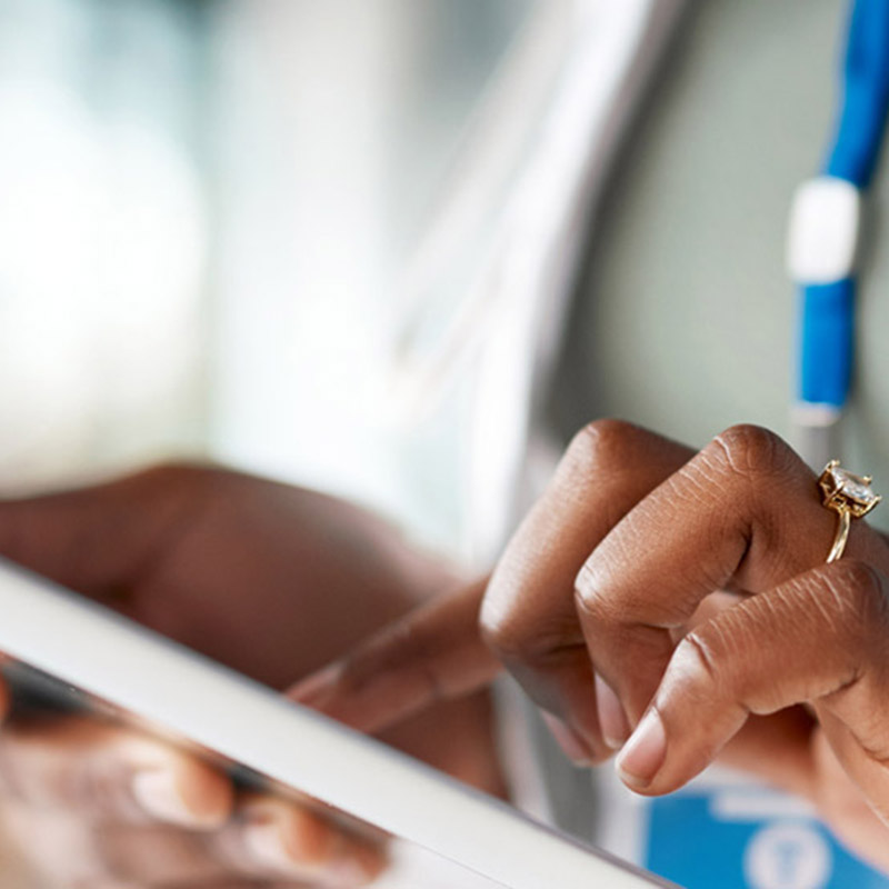 collaborating-scholars-mobile A woman pressing on ipad with her pointer finger