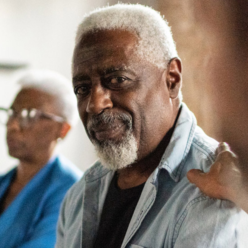 methods-core-mobile A smiling older man with a hand on his shoulder