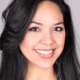 A brown haired woman with a grey photo background