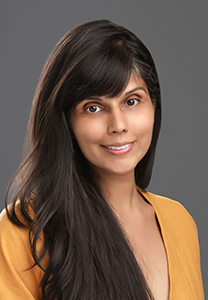 A brown haired woman with a grey photo background